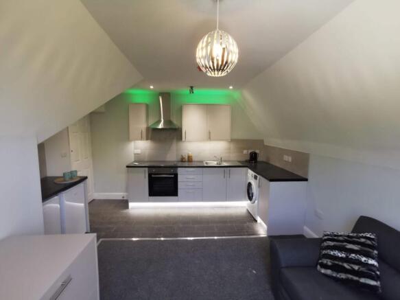 Stylish modern kitchen with vibrant LED lightin...