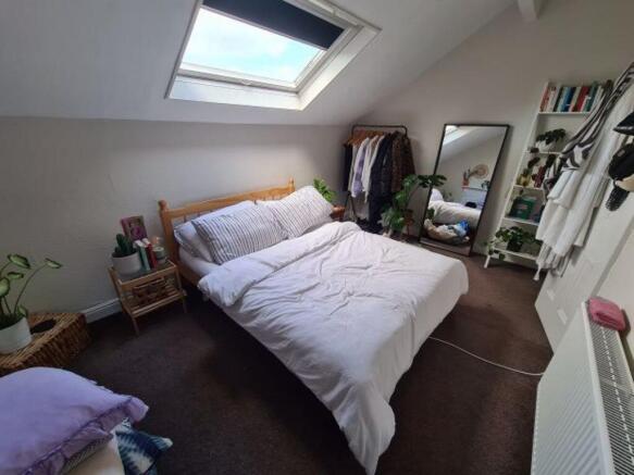 A bright and inviting master bedroom featuring ...