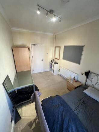 Bright bedroom with double bed and ample storag...