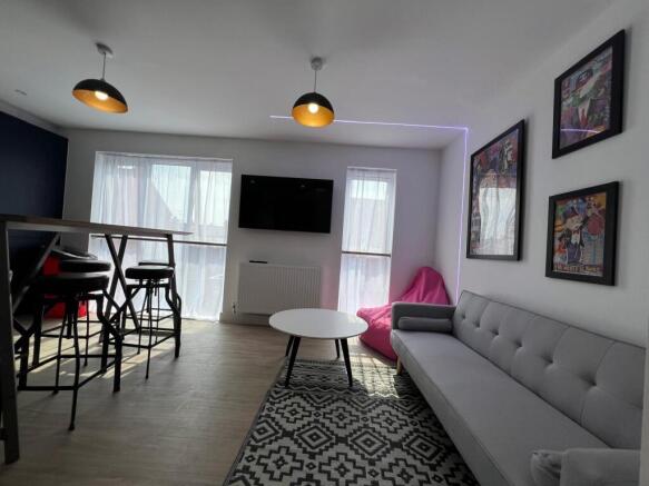 Bright modern living room with a comfy grey sof...