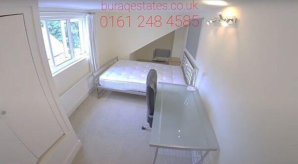 Bright bedroom with large desk and double bed...