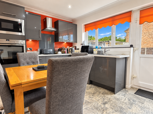 Sunlit Modern Kitchen with Orange Accents.png