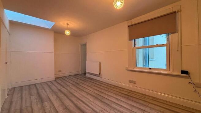 Spacious modern lounge with bright skylight...
