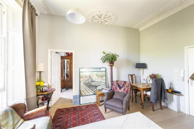 Bright lounge with high ceilings and dining noo...