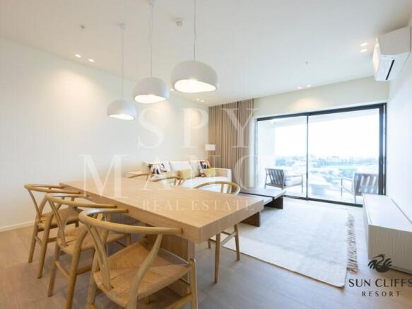 Bright dining room with private balcony access at Sun Cliffs Resort in Lagos, Algarve, ideal for investment.