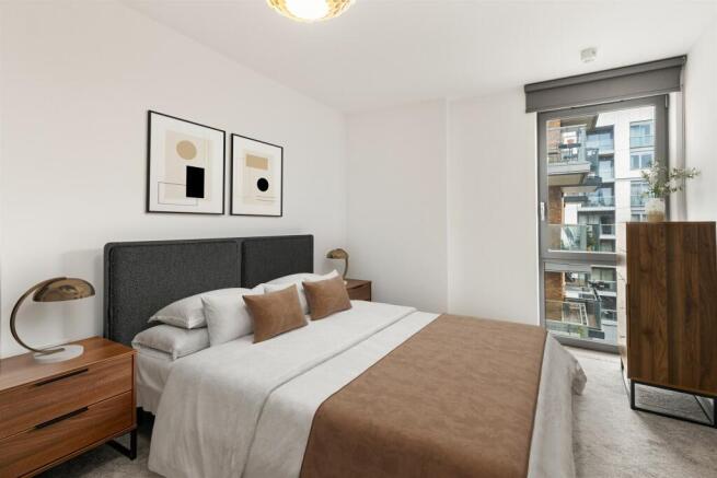 Explore this elegantly designed bedroom, a perfect retreat for relaxation with its modern furnishings and ample natural light.