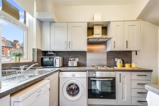 Modern bright kitchen with sleek grey cabinets...