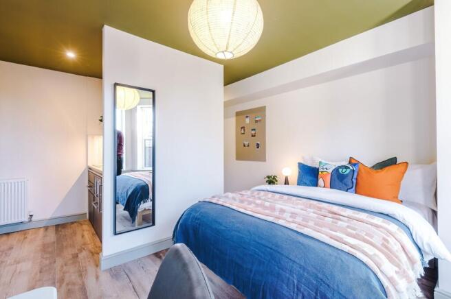Bright, modern double bedroom with a comfy dres...