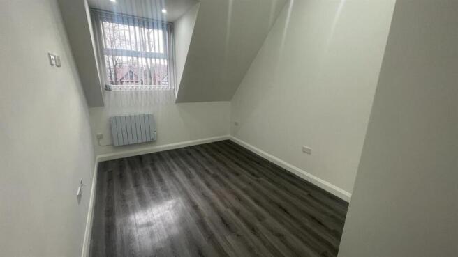 Bright, freshly painted single bedroom with mod...