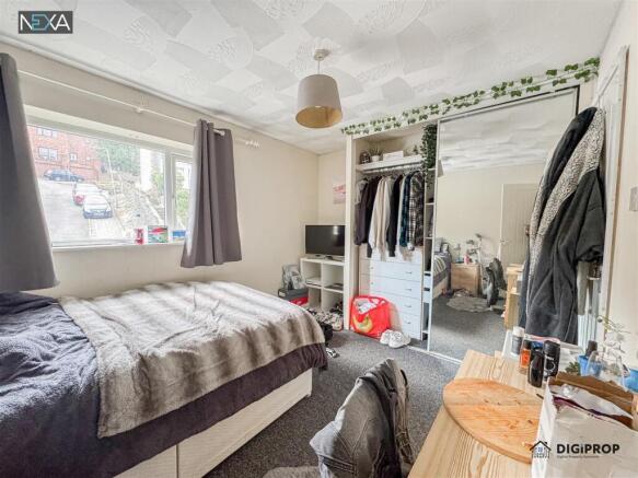 Bright bedroom with ample storage and large bed...