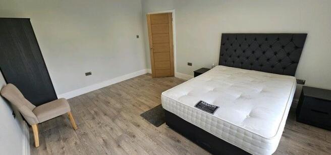 Spacious modern bedroom with plush double bed...