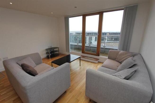 Bright lounge with balcony and plush sofas....