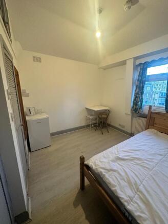 Bright double bedroom with desk and mini-fridge...