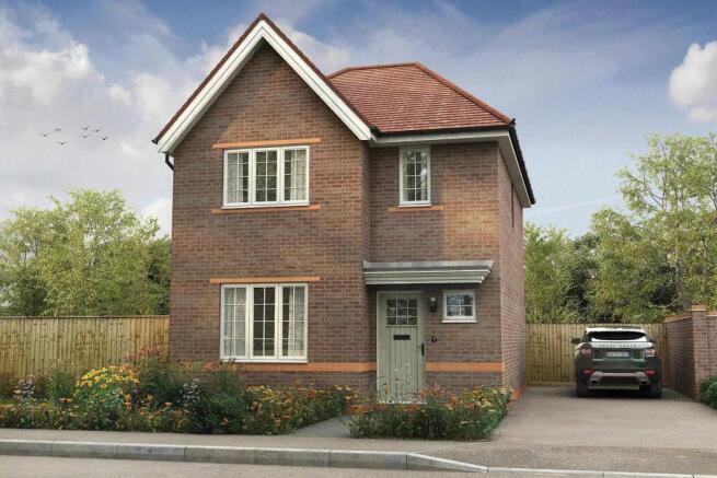 A modern brick house with a green door stands in the foreground