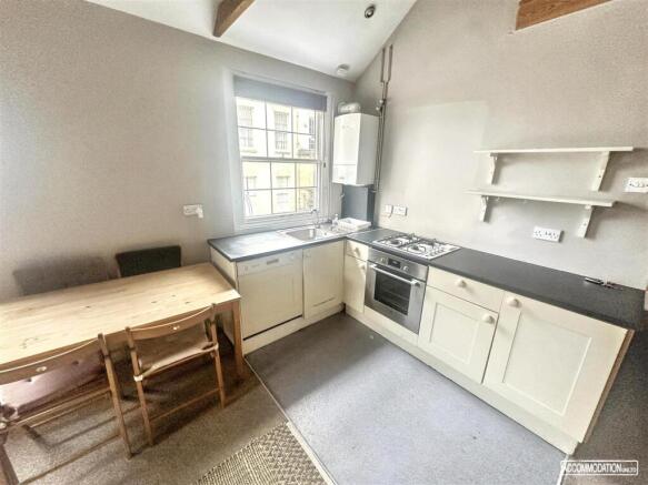 Bright kitchen with dining table and modern uni...