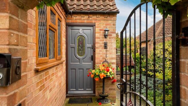 Set behind wrought iron gates