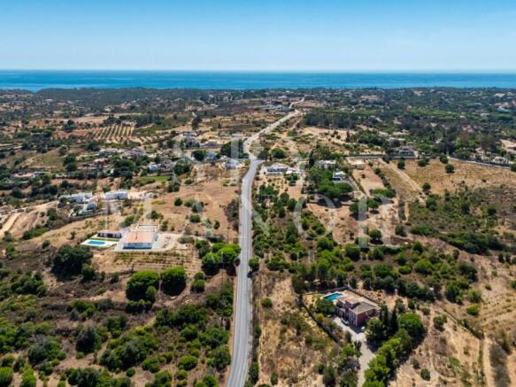 Aerial view of land for sale in Carvoeiro Algarve with sea views. Plot for villa construction near Praia da Marinha, Caramujeira, and Vale d'El Rei.