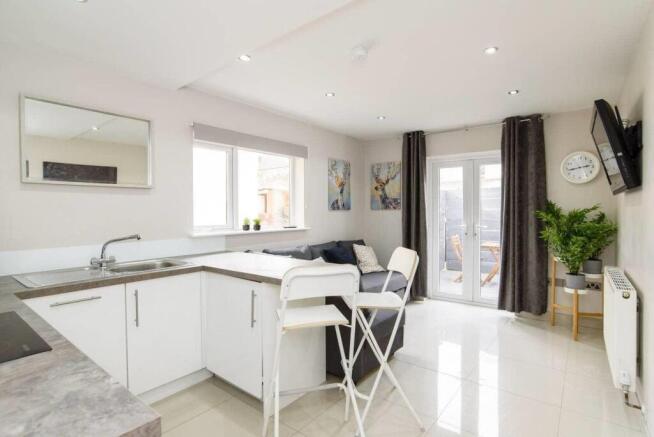 Bright, modern open-plan living with patio door...