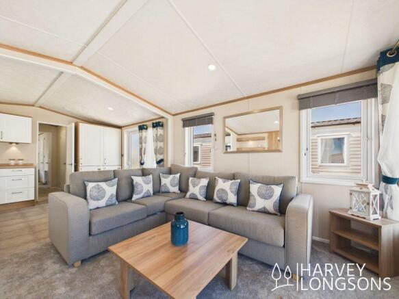 Open plan caravan lounge with L shaped sofa and br