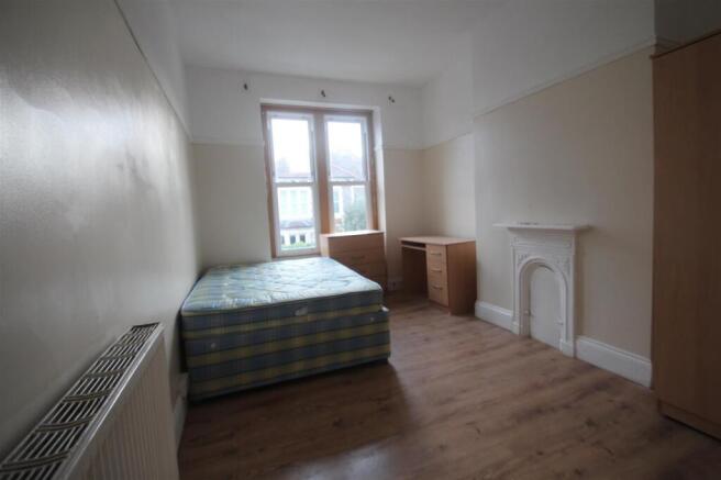 Bright and airy double bedroom featuring a comf...