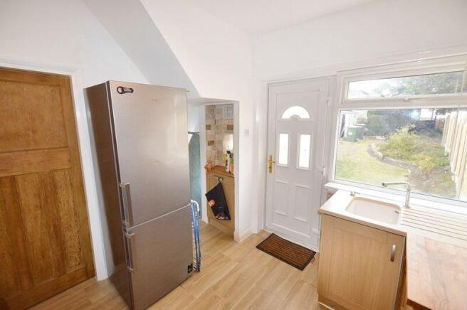 Bright and tidy kitchen featuring modern wooden...