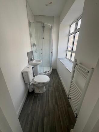 Bright and tidy bathroom featuring a corner sho...