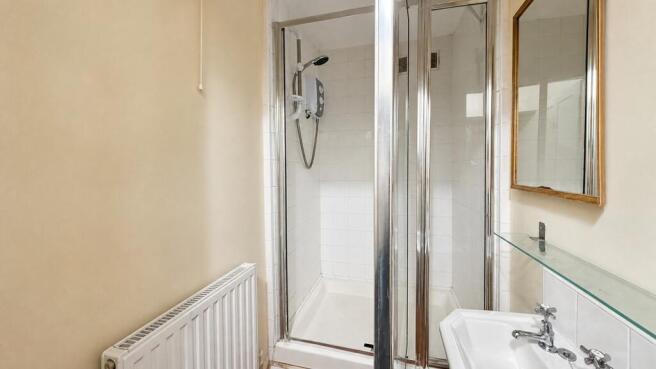 Clean shower room with modern glass cubicle...
