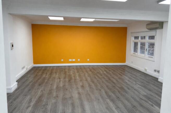Bright modern room with orange accent.png