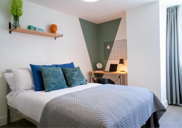 A stylish and well-lit double bedroom featuring...