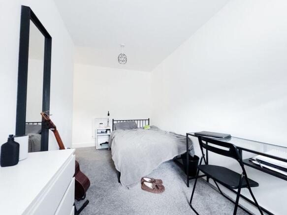 Bright, simply furnished double bedroom with a ...