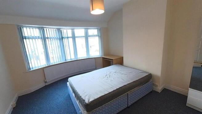 Bright master bedroom with large bay window...