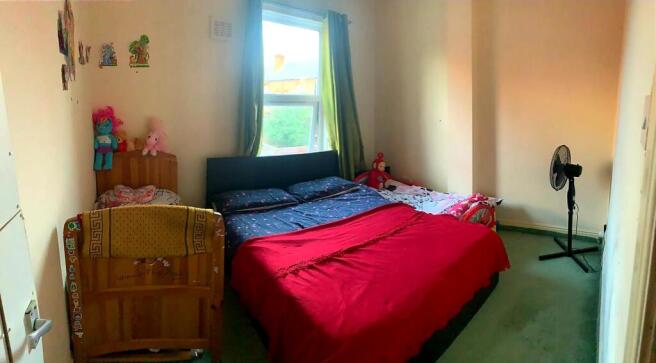 Bright bedroom with a large double bed dressed ...