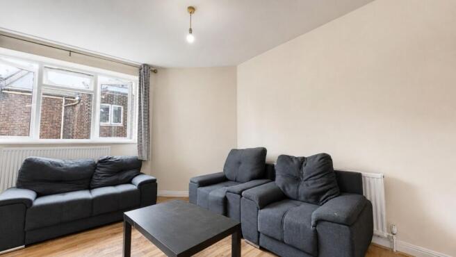 Bright living room with comfortable grey sofas....