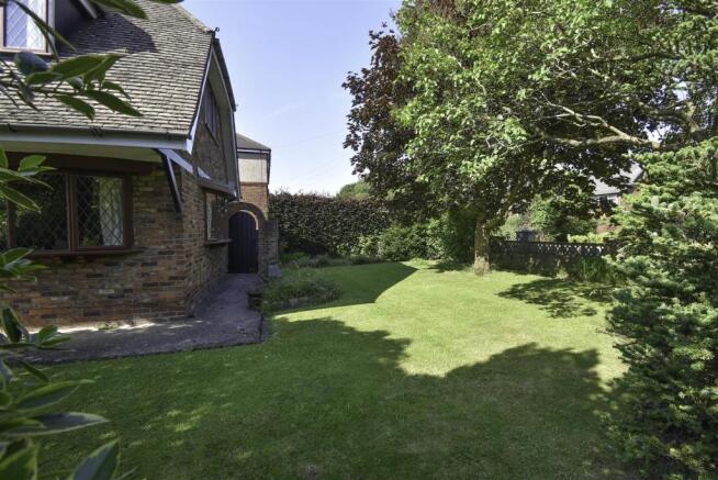 Driveway and mature landscaped gardens