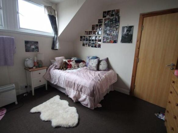 A cozy bedroom featuring a double bed with deco...