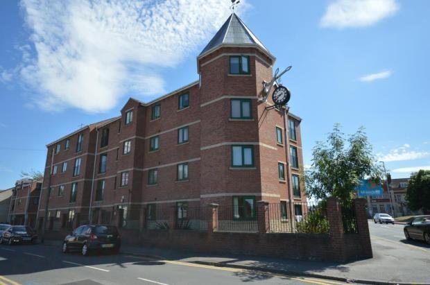 Modern brick building under a bright blue sky...