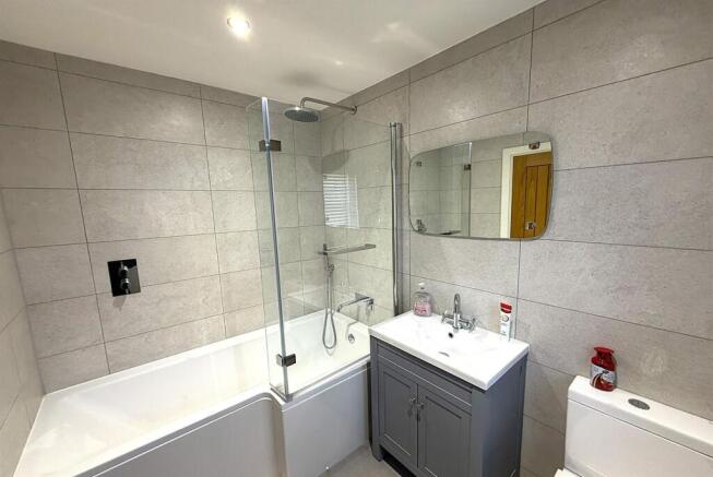 Modern bathroom with sleek tiles and vanity....