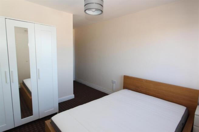 Bright bedroom with ample storage and double be...