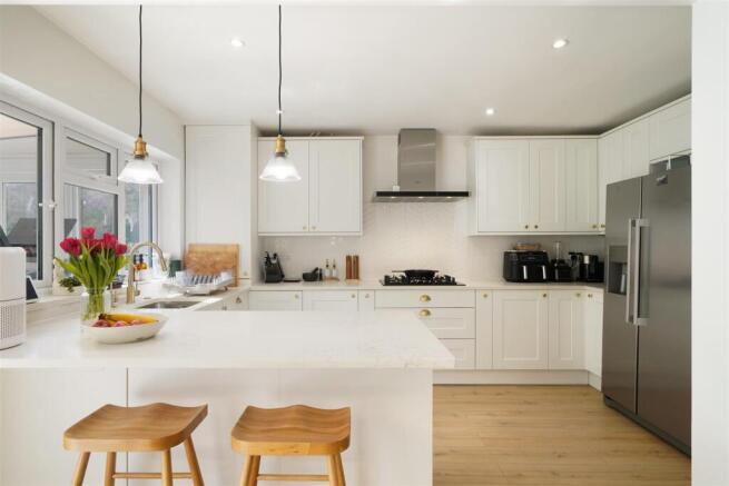 Fitted kitchen with matching breakfast bar
