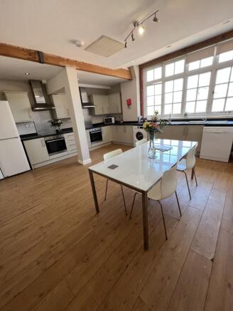Bright, modern open-plan kitchen with large win...