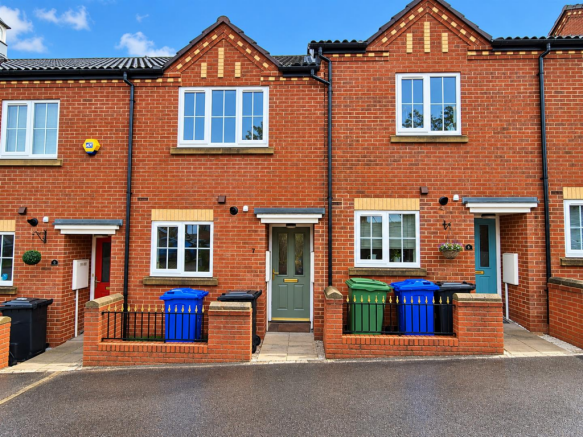 Modern Terraced Homes Under Blue Skies.png