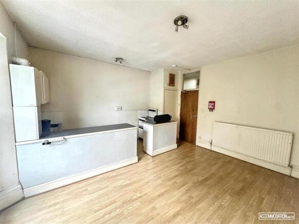 Spacious open kitchen with wood-effect flooring...