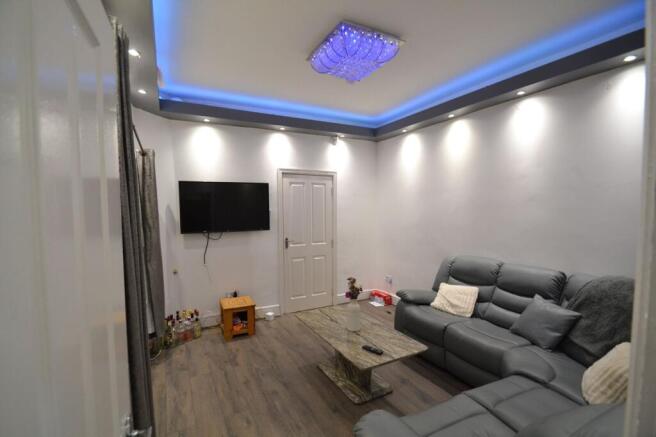 Contemporary living room with a plush grey recl...