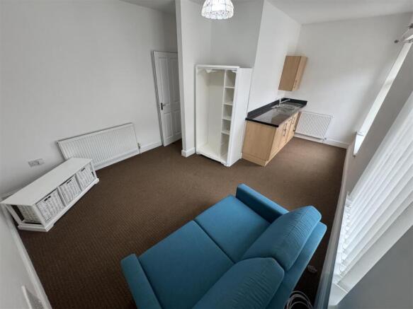 Bright living area with stylish blue sofa...