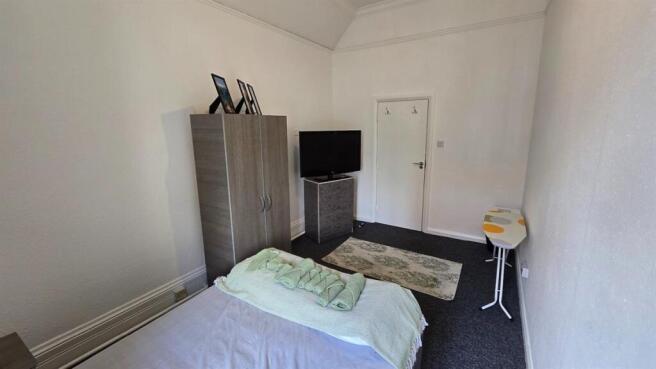 Cozy double bedroom with wardrobe and TV...