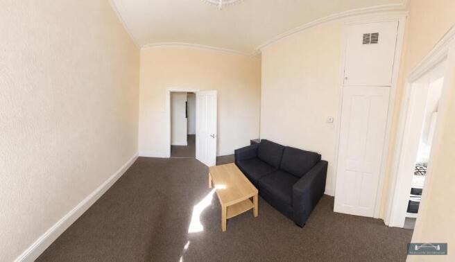 Bright living area with comfy sofa and storage...