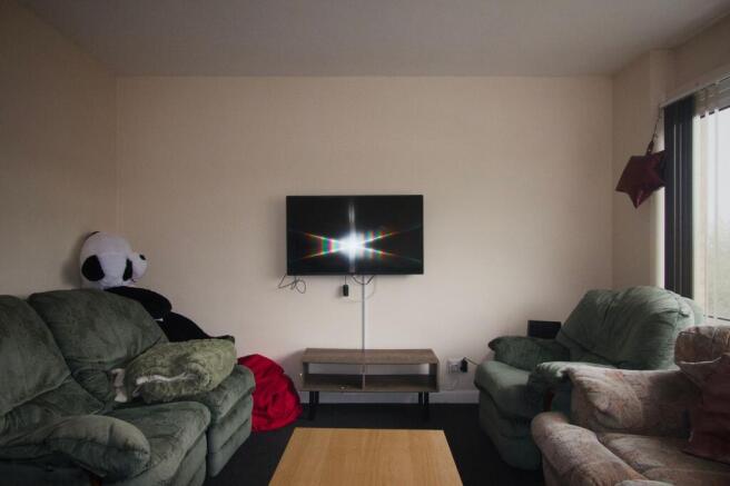 Cosy lounge with comfy seating and wall-and wal...