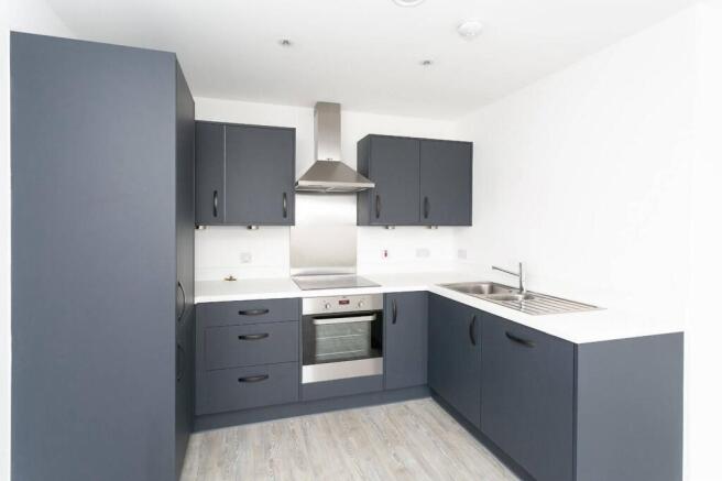 Modern kitchen with sleek navy cabinets...