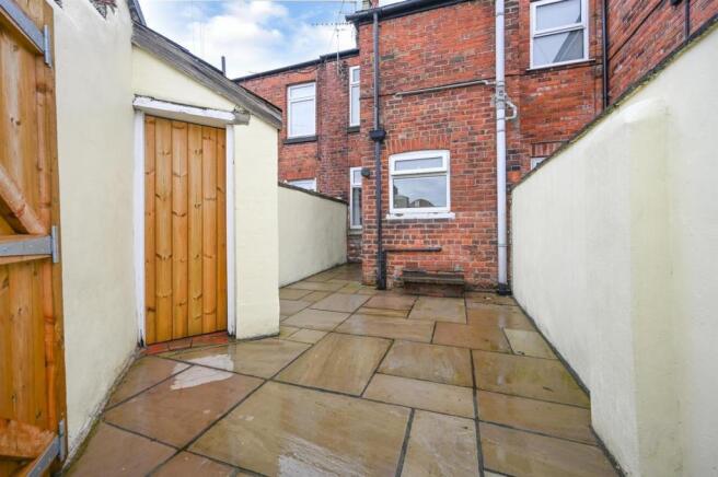 Attractive rear yard with brick storage shed