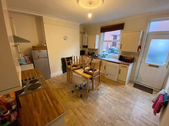 Bright, modern kitchen with wooden worktops, in...